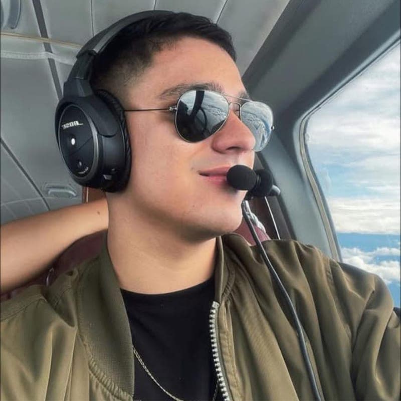 David Cardona Martinez en la cabina de un avión, con cascos de aviación